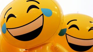 A couple of balloons that have faces on them